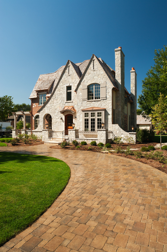 Suburban mansion with paver driveway.